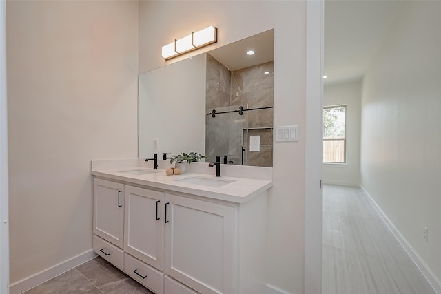 bathroom featuring vanity and tiled shower