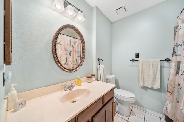 bathroom with vanity, tile patterned floors, and toilet