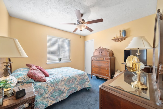 carpeted bedroom with ceiling fan and a textured ceiling