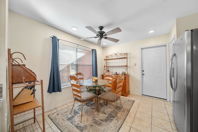 tiled dining space with ceiling fan