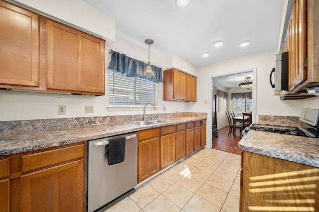 kitchen featuring pendant lighting, sink, light tile patterned floors, and appliances with stainless steel finishes