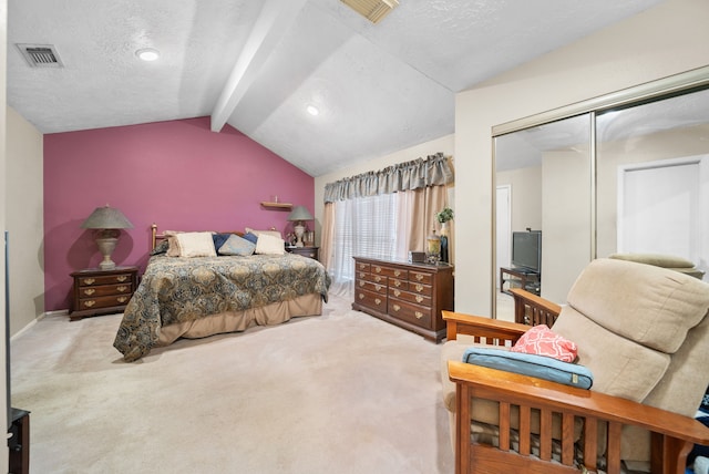 bedroom with lofted ceiling with beams, light colored carpet, a textured ceiling, and a closet