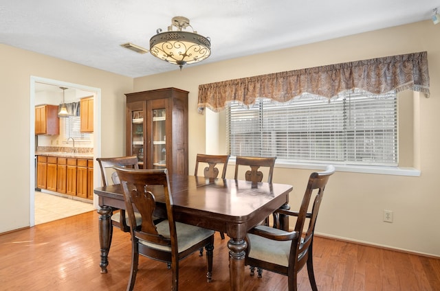 dining space featuring light wood-type flooring