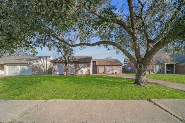 ranch-style home with a garage and a front lawn