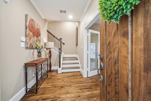 entrance foyer featuring wood-type flooring and crown molding