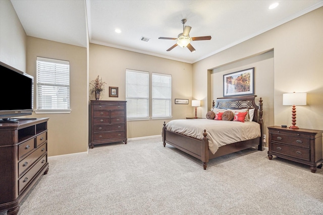 bedroom with ornamental molding, light colored carpet, and ceiling fan