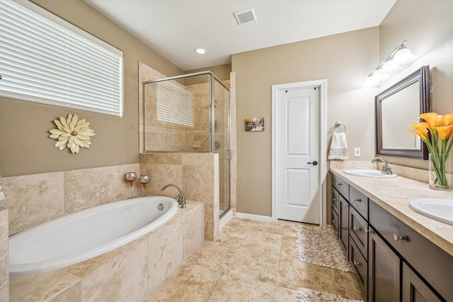 bathroom with vanity and independent shower and bath