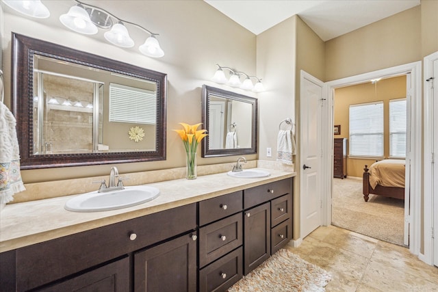 bathroom featuring a shower with door and vanity