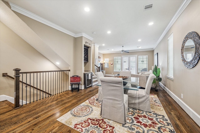 dining space featuring ceiling fan, ornamental molding, and dark hardwood / wood-style floors