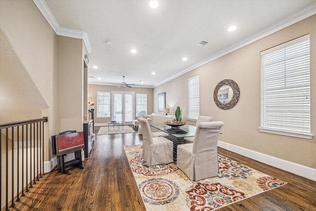 dining space with dark wood-type flooring, ornamental molding, and french doors