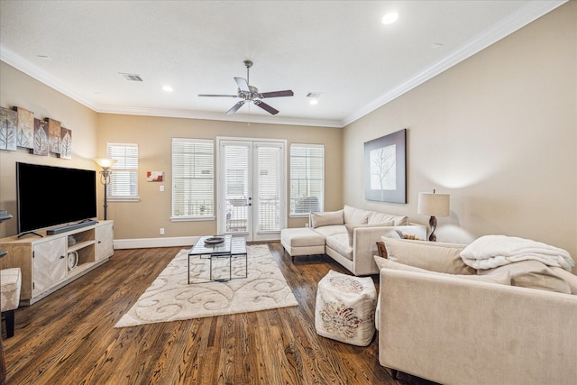 living room featuring dark wood-type flooring, ornamental molding, and ceiling fan