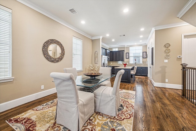 dining area featuring crown molding and dark wood-type flooring