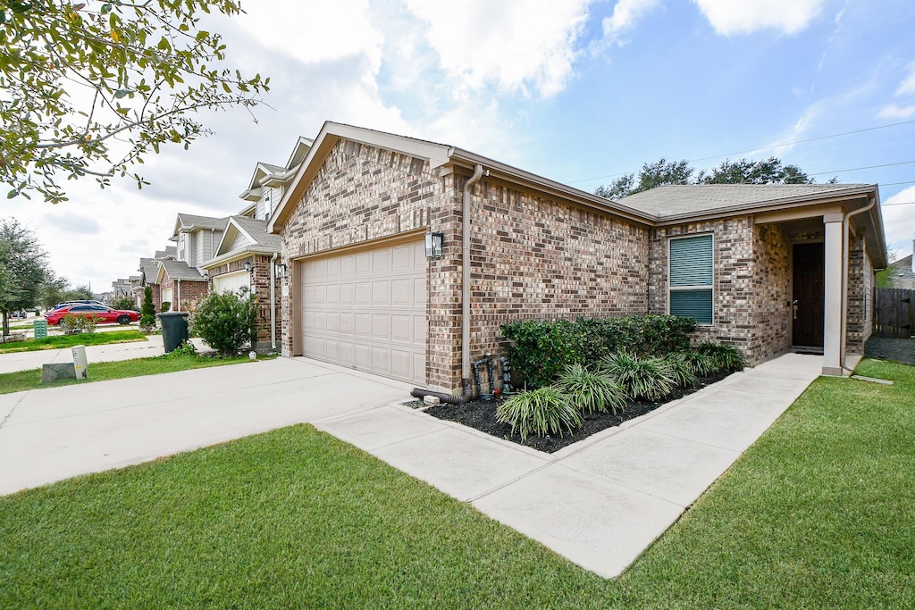 view of side of home with a garage and a yard