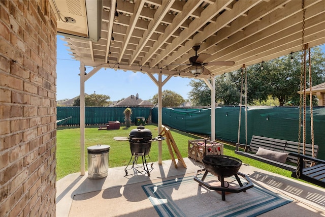 view of patio / terrace with ceiling fan and an outdoor fire pit