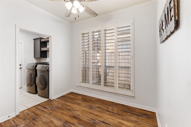 laundry room featuring washer and dryer, ornamental molding, ceiling fan, light hardwood / wood-style floors, and a healthy amount of sunlight