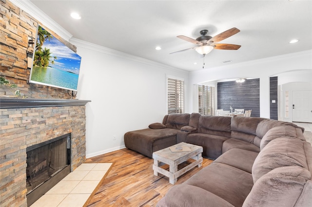 living room featuring a fireplace, light hardwood / wood-style flooring, and ornamental molding