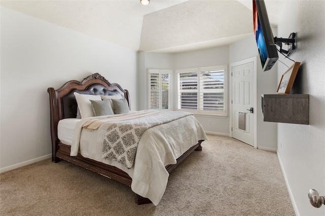 bedroom featuring light carpet and lofted ceiling