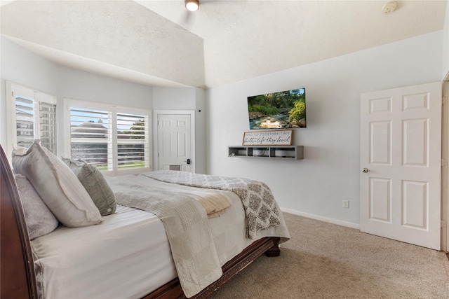 bedroom with lofted ceiling, carpet floors, and a textured ceiling