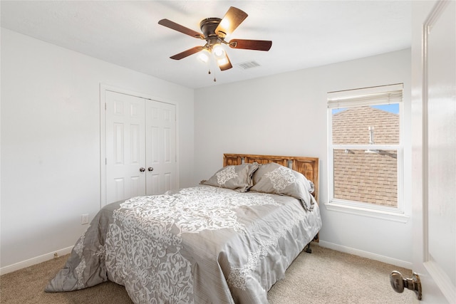 bedroom with light carpet, a closet, and ceiling fan