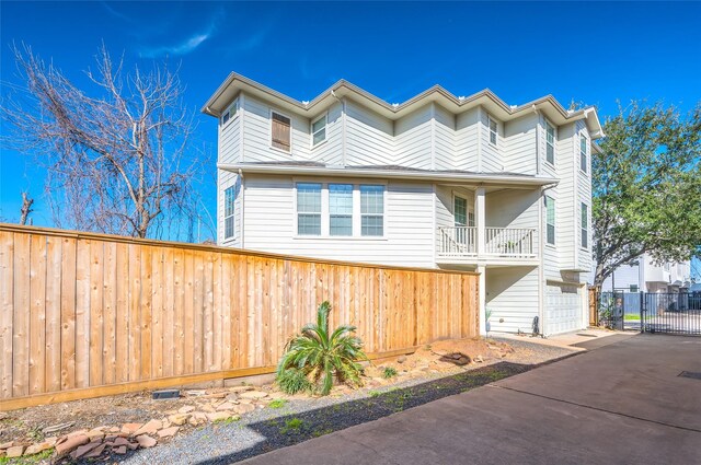 view of front of house with a garage and a balcony