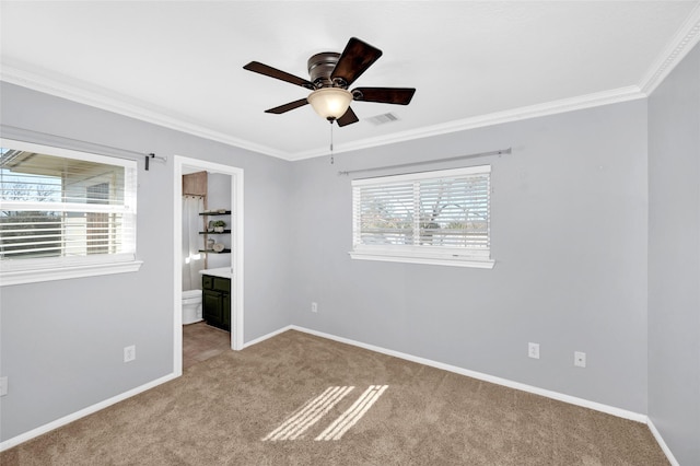 spare room featuring crown molding, light colored carpet, and ceiling fan