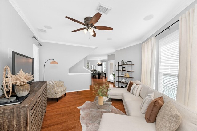 living room with ornamental molding, hardwood / wood-style floors, and ceiling fan