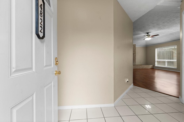 interior space featuring ceiling fan and a textured ceiling