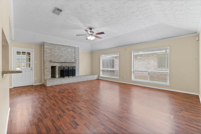 unfurnished living room with ceiling fan, dark wood-type flooring, a textured ceiling, and a fireplace