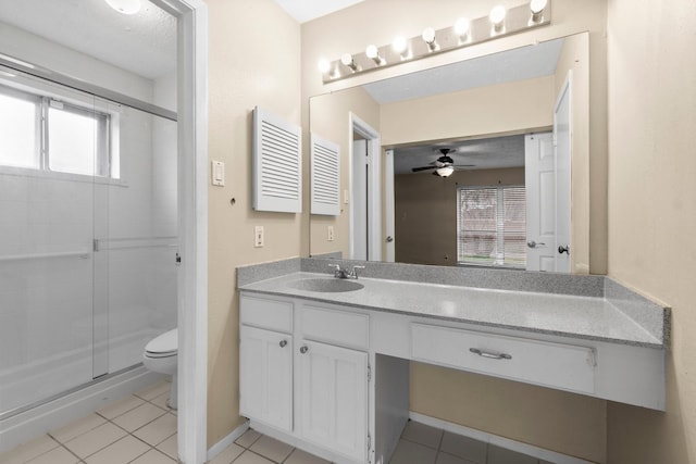 bathroom with vanity, a wealth of natural light, and tile patterned floors