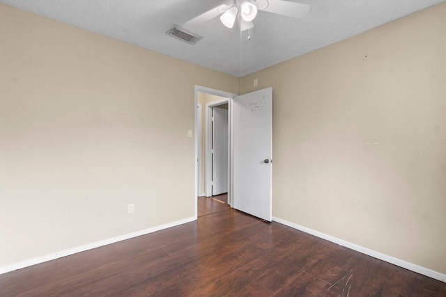 empty room with dark hardwood / wood-style floors and ceiling fan