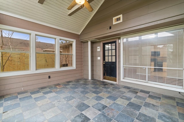 unfurnished sunroom with vaulted ceiling, ceiling fan, and wood ceiling