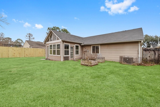 back of house featuring a yard and cooling unit