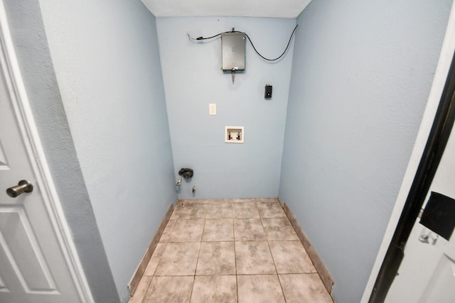 clothes washing area featuring baseboards, laundry area, hookup for a washing machine, light tile patterned flooring, and electric dryer hookup