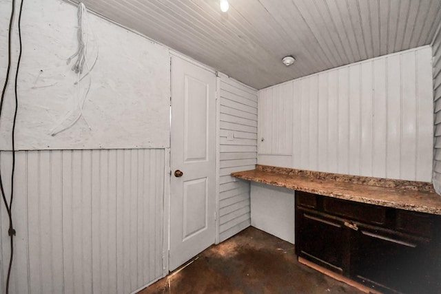 interior space featuring wood ceiling and concrete floors