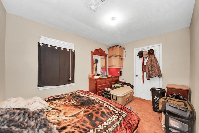 bedroom with visible vents and carpet floors