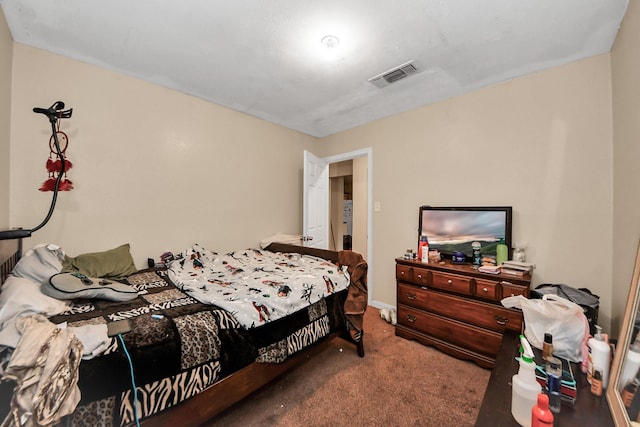 bedroom with visible vents and carpet flooring