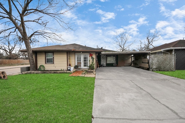 ranch-style home featuring french doors, driveway, a front lawn, and fence