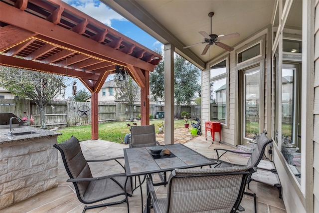 view of patio / terrace featuring ceiling fan and sink