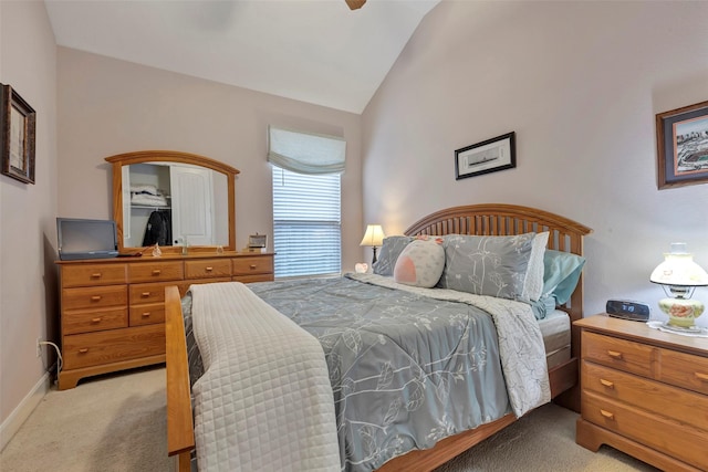 carpeted bedroom featuring vaulted ceiling and ceiling fan