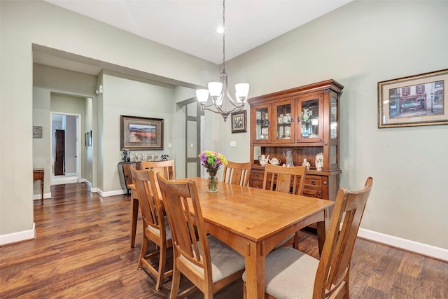 dining area featuring a notable chandelier and dark hardwood / wood-style floors