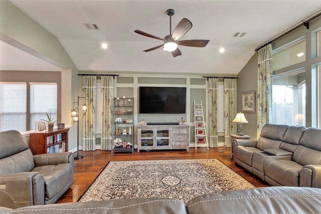 living room featuring dark wood-type flooring, vaulted ceiling, and ceiling fan