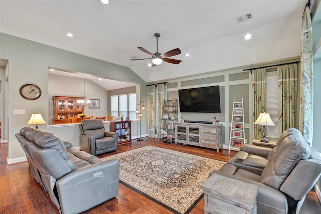 living room featuring lofted ceiling, dark hardwood / wood-style floors, and ceiling fan with notable chandelier