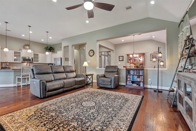 living room featuring dark wood-type flooring, ceiling fan, and vaulted ceiling