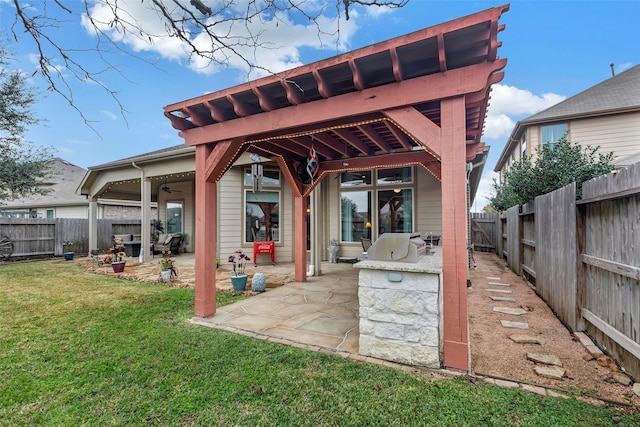 back of property with area for grilling, a yard, ceiling fan, and a patio area