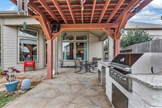 view of patio / terrace featuring sink, grilling area, and an outdoor kitchen