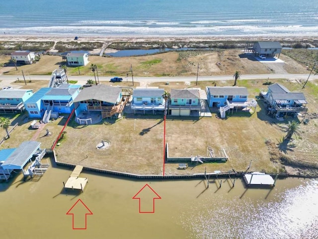 bird's eye view featuring a water view and a beach view