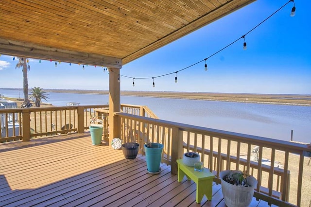 wooden deck featuring a water view