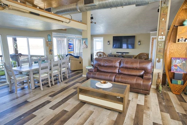 living room featuring wood-type flooring and a textured ceiling