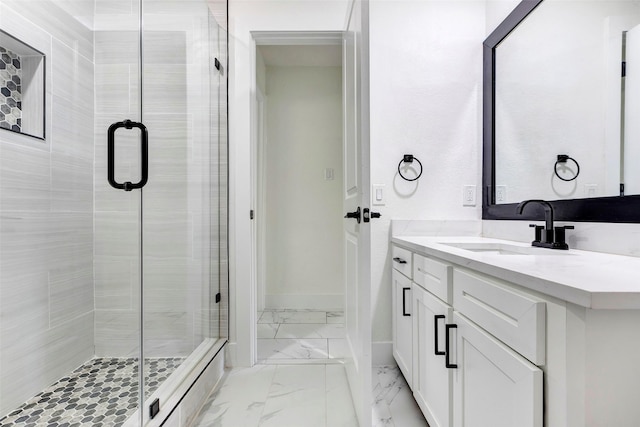 bathroom with vanity and a shower with shower door