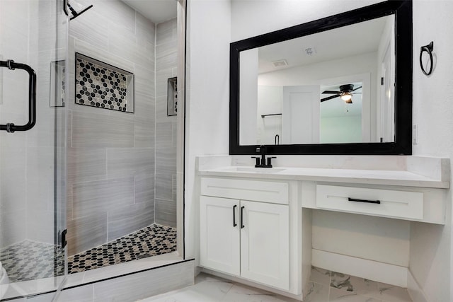 bathroom featuring vanity, a shower with shower door, and ceiling fan